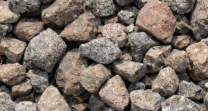Bulk industrial chromite (FeCr₂O₄) stored in a warehouse, ready for stainless steel, ferrochrome, and refractory applications